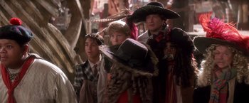 Movie still from “Hook” (1991), directed by Steven Spielberg – A group of people standing next to each other wearing hats; Medium shot, Low angle
