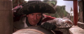 Movie still from “Hook” (1991), directed by Steven Spielberg – A man wearing a cowboy hat looking at the camera; Close Up shot, Over the shoulder angle