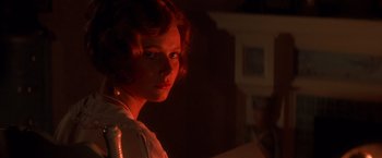 Movie still from “Hook” (1991), directed by Steven Spielberg – A woman with red curly hair is standing in a room; Close Up shot, Low angle