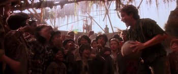 Movie still from “Hook” (1991), directed by Steven Spielberg – A group of people standing next to each other; Medium shot, Low angle