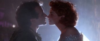 Movie still from “Hook” (1991), directed by Steven Spielberg – A man and a woman face to face in a dark room; Close Up shot, Low angle