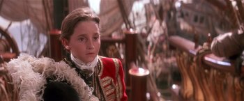 Movie still from “Hook” (1991), directed by Steven Spielberg – A young girl in a red and white uniform; Close Up shot, Over the shoulder angle