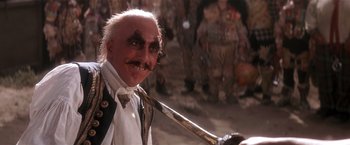 Movie still from “Hook” (1991), directed by Steven Spielberg – An old man with a mustache and a long tie; Close Up shot, Low angle