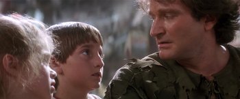 Movie still from “Hook” (1991), directed by Steven Spielberg – A man and a boy looking at each other; Close Up shot, Over the shoulder angle