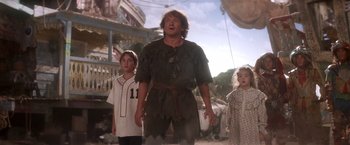 Movie still from “Hook” (1991), directed by Steven Spielberg – A group of people standing next to each other on a street; Medium shot, Low angle