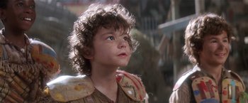Movie still from “Hook” (1991), directed by Steven Spielberg – A young boy looking up into the sky; Close Up shot, Low angle