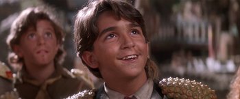 Movie still from “Hook” (1991), directed by Steven Spielberg – A person smiling; Close Up shot, Low angle