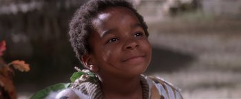 Movie still from “Hook” (1991), directed by Steven Spielberg – A child smiling at the camera; Close Up shot, Low angle