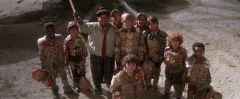 Movie still from “Hook” (1991), directed by Steven Spielberg – A group of children in costumes posing for a picture; Medium shot, High angle