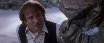 Movie still from “Hook” (1991), directed by Steven Spielberg – A person near a statue of a person; Close Up shot, Over the shoulder angle