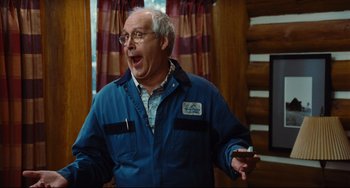 Movie still from “Hot Tub Time Machine” (2010), directed by Steve Pink – An older man in a blue jacket is holding a remote control; Medium shot, Low angle