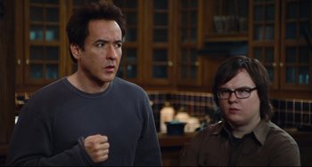 Movie still from “Hot Tub Time Machine” (2010), directed by Steve Pink – A man and a woman standing next to each other in a kitchen; Medium shot, Over the shoulder angle