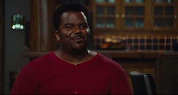 Movie still from “Hot Tub Time Machine” (2010), directed by Steve Pink – A man in a red shirt is smiling for the camera; Medium shot, Over the shoulder angle