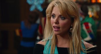 Movie still from “Hot Tub Time Machine” (2010), directed by Steve Pink – A woman with long blonde hair wearing a black and blue top; Close Up shot, Over the shoulder angle