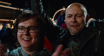 Movie still from “Hot Tub Time Machine” (2010), directed by Steve Pink – A man and a woman posing for a picture; Close Up shot, Over the shoulder angle