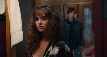 Movie still from “Hot Tub Time Machine” (2010), directed by Steve Pink – A young woman with long brown hair wearing a black and white dress; Close Up shot, Over the shoulder angle