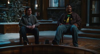 Movie still from “Hot Tub Time Machine” (2010), directed by Steve Pink – Two men sitting on chairs in front of each other; Wide shot, High angle