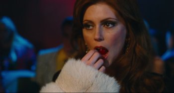 Movie still from “Hot Tub Time Machine” (2010), directed by Steve Pink – A woman with red lipstick and a fur coat; Close Up shot, Over the shoulder angle