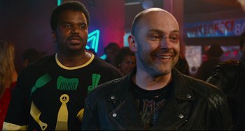 Movie still from “Hot Tub Time Machine” (2010), directed by Steve Pink – Two men are standing in front of a crowd of people; Close Up shot, Over the shoulder angle