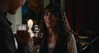 Movie still from “Hot Tub Time Machine” (2010), directed by Steve Pink – A woman sitting in front of a man holding a glass of red wine; Close Up shot, Over the shoulder angle