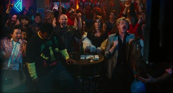 Movie still from “Hot Tub Time Machine” (2010), directed by Steve Pink – A group of people are watching a game in a bar; Wide shot, High angle