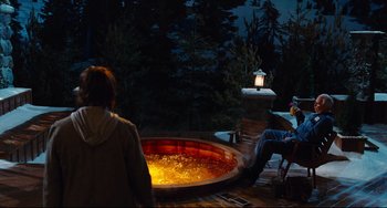 Movie still from “Hot Tub Time Machine” (2010), directed by Steve Pink – Two people sitting in front of an outdoor hot tub at night; Wide shot, High angle