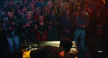 Movie still from “Hot Tub Time Machine” (2010), directed by Steve Pink – A crowd of people watching a man play the piano; Wide shot, High angle