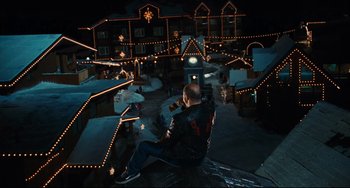 Movie still from “Hot Tub Time Machine” (2010), directed by Steve Pink – A man sitting on the side of a building at night; Extreme Wide shot, High angle