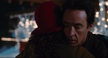 Movie still from “Hot Tub Time Machine” (2010), directed by Steve Pink – A man in a red hat is hugging a woman; Close Up shot, Over the shoulder angle