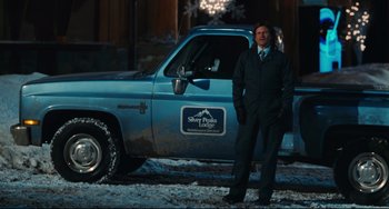Movie still from “Hot Tub Time Machine” (2010), directed by Steve Pink – A man standing in front of a truck in the snow; Wide shot, Over the shoulder angle
