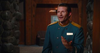 Movie still from “Hot Tub Time Machine” (2010), directed by Steve Pink – A man in a blue and yellow uniform talking to someone; Medium shot, Over the shoulder angle