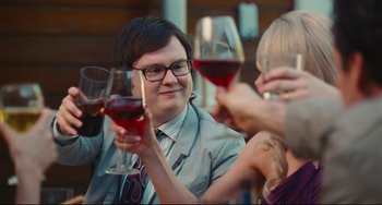Movie still from “Hot Tub Time Machine” (2010), directed by Steve Pink – A group of people sitting at a table holding wine glasses; Close Up shot, Over the shoulder angle