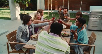 Movie still from “Hot Tub Time Machine” (2010), directed by Steve Pink – A group of people sitting at a table drinking wine; Wide shot, High angle