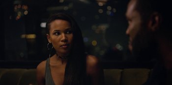 Movie still from “Black Mirror” (2011), created by Charlie Brooker – A woman sitting in front of a man in front of a window at night; Close Up shot, Over the shoulder angle