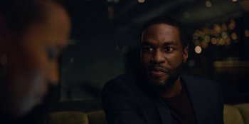 Movie still from “Black Mirror” (2011), created by Charlie Brooker – A man sitting in a chair in front of another man; Close Up shot, Over the shoulder angle