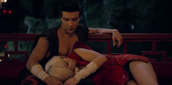 Movie still from “Black Mirror” (2011), created by Charlie Brooker – A man and a woman laying on a bench; Medium shot, High angle