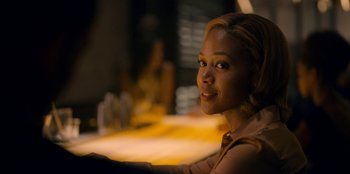 Movie still from “Black Mirror” (2011), created by Charlie Brooker – A woman sitting at a table in front of a window; Close Up shot, Over the shoulder angle