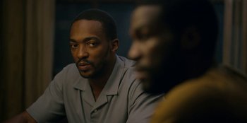 Movie still from “Black Mirror” (2011), created by Charlie Brooker – Two men sitting in front of each other in a room; Close Up shot, Over the shoulder angle