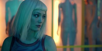Movie still from “Black Mirror” (2011), created by Charlie Brooker – A woman with blonde hair and a white wig; Close Up shot, Over the shoulder angle