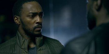 Movie still from “Black Mirror” (2011), created by Charlie Brooker – A person wearing a jacket; Close Up shot, Over the shoulder angle