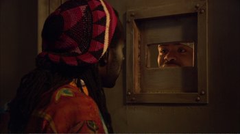 Movie still from “How High” (2001), directed by Jesse Dylan – A man looking into a mirror while standing next to a woman; Close Up shot, Over the shoulder angle