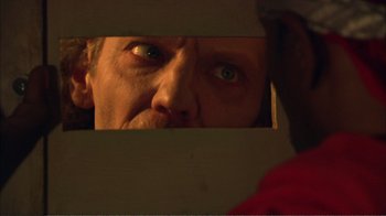 Movie still from “How High” (2001), directed by Jesse Dylan – A person looking at their reflection in a mirror; Extreme Close Up shot, Over the shoulder angle