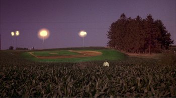 Movie still from “How High” (2001), directed by Jesse Dylan – A person sitting in the middle of a field at night; Extreme Wide shot, High angle