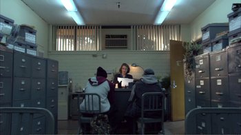 Movie still from “How High” (2001), directed by Jesse Dylan – A group of people sitting at a table with a laptop computer; Wide shot, Over the shoulder angle