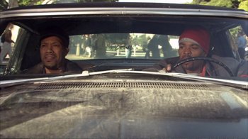 Movie still from “How High” (2001), directed by Jesse Dylan – Two men in the back seat of a car; Medium shot, Over the shoulder angle