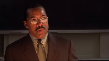 Movie still from “How High” (2001), directed by Jesse Dylan – A man in a suit and tie looking at the camera; Close Up shot, Low angle