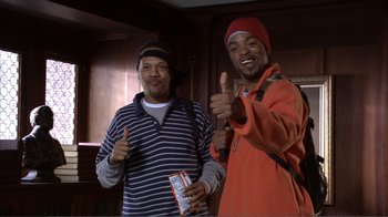 Movie still from “How High” (2001), directed by Jesse Dylan – Two men giving the thumbs up in front of a window; Medium shot, High angle