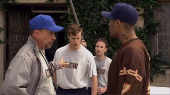 Movie still from “How High” (2001), directed by Jesse Dylan – A group of men standing next to each other on a field; Medium shot, Over the shoulder angle