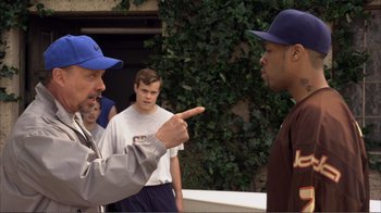 Movie still from “How High” (2001), directed by Jesse Dylan – A man in a blue hat is pointing at another man in a blue hat; Medium shot, Over the shoulder angle