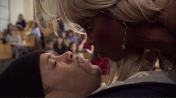 Movie still from “How High” (2001), directed by Jesse Dylan – A man and a woman kissing in front of a crowd; Close Up shot, Overhead angle